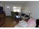 Comfortable living room with a sofa, armchair, and natural light from the window at 1395 Heather Ridge Blvd, Dunedin, FL 34698