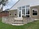 Backyard of home with patio featuring stone steps and large windows on the house at 1415 Saddle Gold Ct, Brandon, FL 33511