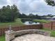 Backyard with stone patio featuring a view of the lake at 1415 Saddle Gold Ct, Brandon, FL 33511