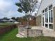 Large backyard features a patio, fence, and large windows on the back of house at 1415 Saddle Gold Ct, Brandon, FL 33511
