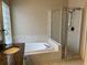 Bathroom features a granite countertop, soaking tub and glass-enclosed shower at 1415 Saddle Gold Ct, Brandon, FL 33511