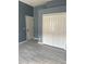 Bedroom featuring a large closet, door to another room and modern flooring at 1415 Saddle Gold Ct, Brandon, FL 33511