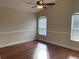 Spacious bedroom with ceiling fan, two windows and hardwood floors at 1415 Saddle Gold Ct, Brandon, FL 33511