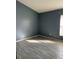 Empty bedroom with blue walls and modern floor tiles at 1415 Saddle Gold Ct, Brandon, FL 33511