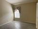 Neutral bedroom features tile floors and lots of natural light from the window at 1415 Saddle Gold Ct, Brandon, FL 33511