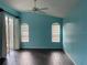 Spacious bedroom features ceiling fan, two windows, wood-look flooring and patio access at 1415 Saddle Gold Ct, Brandon, FL 33511