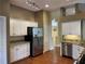 Well-equipped kitchen with granite countertops, stainless steel appliances, and white cabinets at 1415 Saddle Gold Ct, Brandon, FL 33511