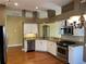 Modern kitchen features granite countertops, stainless steel appliances, and white cabinets at 1415 Saddle Gold Ct, Brandon, FL 33511