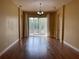 Spacious living room with hardwood floors, large windows, and access to an outdoor area at 1415 Saddle Gold Ct, Brandon, FL 33511