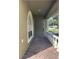 Charming front porch with brick flooring, columns, and white railing, providing a welcoming entrance at 1415 Saddle Gold Ct, Brandon, FL 33511