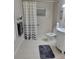 A bathroom with a walk-in shower with gray shower curtain and tiled floors at 16106 Bridgedale Dr, Lithia, FL 33547