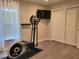 A workout area in bedroom with hardwood floors and a television at 16106 Bridgedale Dr, Lithia, FL 33547