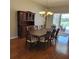 Spacious dining room with a large wooden table, seating for eight, and elegant chandelier lighting at 16106 Bridgedale Dr, Lithia, FL 33547