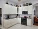 Well-lit kitchen with white cabinetry, stainless steel appliances, and modern countertops at 16106 Bridgedale Dr, Lithia, FL 33547