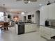Open-concept kitchen with island, stainless steel dishwasher, and view of living area at 16106 Bridgedale Dr, Lithia, FL 33547