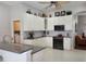 Bright kitchen with white cabinets, stainless steel appliances, and granite countertops at 16106 Bridgedale Dr, Lithia, FL 33547