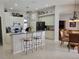 Open-concept kitchen with island, stainless steel dishwasher, and view of dining area at 16106 Bridgedale Dr, Lithia, FL 33547