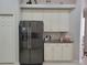 Modern kitchen with stainless steel refrigerator and white cabinets at 16106 Bridgedale Dr, Lithia, FL 33547