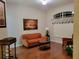 Cozy living room features a comfortable orange sofa and bright natural light from the large window at 16106 Bridgedale Dr, Lithia, FL 33547