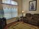 Cozy living room with a large window, comfortable seating, and warm natural light at 16106 Bridgedale Dr, Lithia, FL 33547