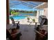 Screened in patio with outdoor seating, grill, and a scenic water view at 16106 Bridgedale Dr, Lithia, FL 33547