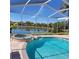 Screened in pool with inground spa and a scenic water view at 16106 Bridgedale Dr, Lithia, FL 33547