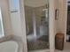 Modern glass-enclosed shower with tiled walls, built-in shelving, and a seating bench at 16106 Bridgedale Dr, Lithia, FL 33547