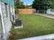 Backyard with well-kept lawn, chainlink fence, privacy fence, and air conditioning unit at 1626 27Th N Ave, St Petersburg, FL 33713