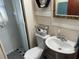Bathroom featuring a toilet, sink, framed mirror, and glass door enclosed shower at 1626 27Th N Ave, St Petersburg, FL 33713