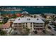 Aerial view of condo near bay; on-site parking, boat access, and beach nearby at 1700 Pass A Grille Way # 9, St Pete Beach, FL 33706