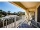 A cozy balcony features a table and chairs and a view of the neighborhood at 1700 Pass A Grille Way # 9, St Pete Beach, FL 33706