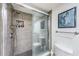 An updated bathroom featuring a sleek glass-enclosed shower and a modern tile design at 1700 Pass A Grille Way # 9, St Pete Beach, FL 33706