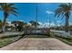 Well-maintained Col. Frank Hurley Park with palm trees and walking path at 1700 Pass A Grille Way # 9, St Pete Beach, FL 33706