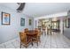 Bright dining area with tile floors features a wood table with seating for four and an adjacent breakfast bar at 1700 Pass A Grille Way # 9, St Pete Beach, FL 33706