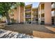 Inviting condo exterior with white railing balconies, light brown stone wall accents, and well-maintained landscaping at 1700 Pass A Grille Way # 9, St Pete Beach, FL 33706