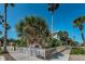 Exterior of a building with palm trees, a picket fence, and 'Gifts Galore' sign at 1700 Pass A Grille Way # 9, St Pete Beach, FL 33706