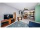 Spacious living room with tile flooring, ceiling fan, and a view into the adjacent dining area and kitchen at 1700 Pass A Grille Way # 9, St Pete Beach, FL 33706