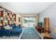 Bright living room with balcony, comfortable seating, and a bookshelf creates a cozy space for relaxation at 1700 Pass A Grille Way # 9, St Pete Beach, FL 33706