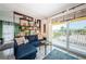 Comfortable living room with sliding doors to balcony and bookshelf divider to an adjacent bedroom at 1700 Pass A Grille Way # 9, St Pete Beach, FL 33706