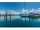 Scenic view of a marina with docked sailboats, calm water, and blue sky with clouds at 1700 Pass A Grille Way # 9, St Pete Beach, FL 33706
