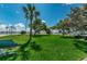 Lush green park view with mature trees, benches, and well-manicured lawn, creating a peaceful community space at 1700 Pass A Grille Way # 9, St Pete Beach, FL 33706