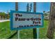 Sign for The Pass-a-Grille Park in City of St. Pete Beach surrounded by green foliage at 1700 Pass A Grille Way # 9, St Pete Beach, FL 33706