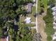 An aerial view of a home backing up to a waterway surrounded by mature trees at 17111 Mockingbird Ln, Lutz, FL 33548