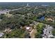 An aerial view highlights this home nestled among trees, with a property outline marked in red for clarity at 17111 Mockingbird Ln, Lutz, FL 33548