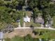 Aerial view of the charming home with a waterway in the back and luscious landscaping at 17111 Mockingbird Ln, Lutz, FL 33548