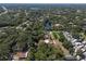 A picturesque aerial view of the home nestled among lush trees, property line outlined in red for clarity at 17111 Mockingbird Ln, Lutz, FL 33548
