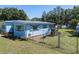 House with small playground area and chain link fence in the yard at 17111 Mockingbird Ln, Lutz, FL 33548