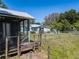 View of a home from a screened-in porch, showcasing a neatly fenced backyard and inviting outdoor space at 17111 Mockingbird Ln, Lutz, FL 33548