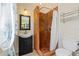 Tiled shower with mosaic floor and vanity with black cabinet in renovated bathroom at 17111 Mockingbird Ln, Lutz, FL 33548