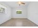 Spare bedroom with carpet, ceiling fan and natural light from large windows at 17111 Mockingbird Ln, Lutz, FL 33548